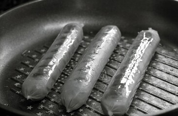 Tasty sausages and vegetables isolated over solid background