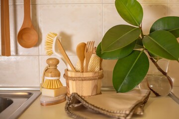 Zero waste concept. Eco-friendly kitchen accessories. Brushes, natural soap, A woman washes dishes with natural products and a brush. Waste-free eco-friendly house