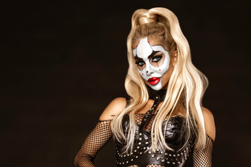 Sexy woman in a Halloween makeup on black background.