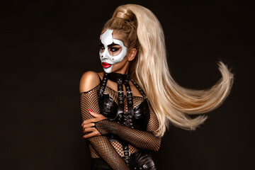 Sexy woman in a Halloween makeup on black background.