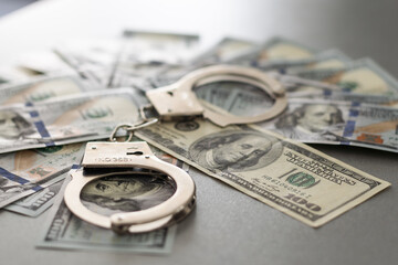 Handcuffs Laying on Newly Designed U.S. One Hundred Dollar Bills.