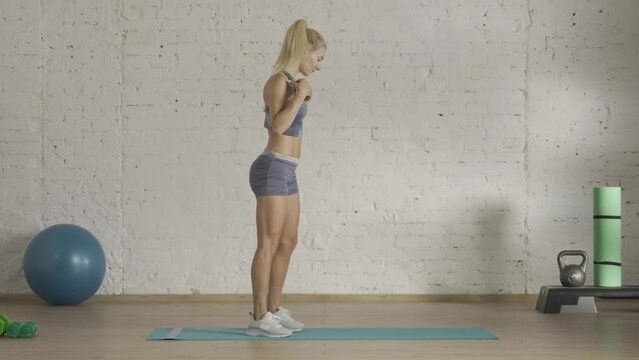 Healthcare and wellness advertisement concept. Athletic woman fitness coach doing knee push up exercise for online classes. HDR BT2020 HLG material.