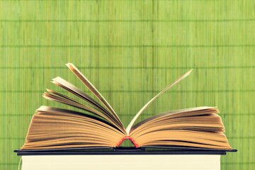 Close-up shot of open old book laying on another book