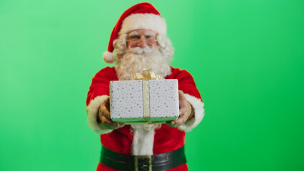 Studio Shot Isolated Mockup Template: Jolly Santa Claus Offering Beautifully Wrapped Gift To Children On Green Screen Chromakey Background. Concept Of Christmas, New Year, Celebration