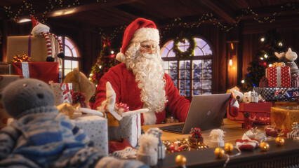 Merry Santa Claus Sitting Behind a Desk and Working on Laptop Computer. Senior Santa Shopping Online, Fulfilling Gift Orders for Christmas and New Year. Advertising Footage for Winter Holidays