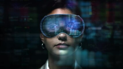 Dolly In of Young Female Financial Broker Working with VR Glasses. Augmented Reality Headsets with Economy Elements appearing. Charts, Graphs and Stock Exchange Data.
 - Powered by Adobe