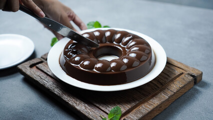Chocolate Pudding on a white plate on a gray background.
