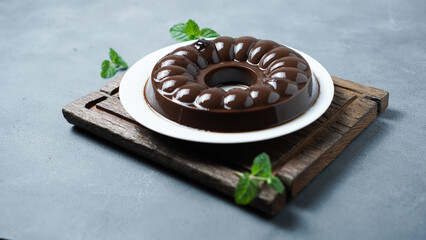 Chocolate Pudding on a white plate on a gray background.