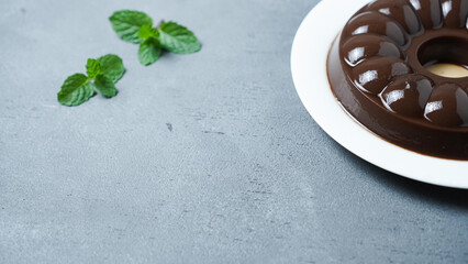Chocolate Pudding on a white plate on a gray background.