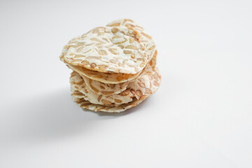 Keripik Tempe or Tempeh Chips are made from soybeans mixed with rice flour then sliced ​​thinly. Isolated on white background.