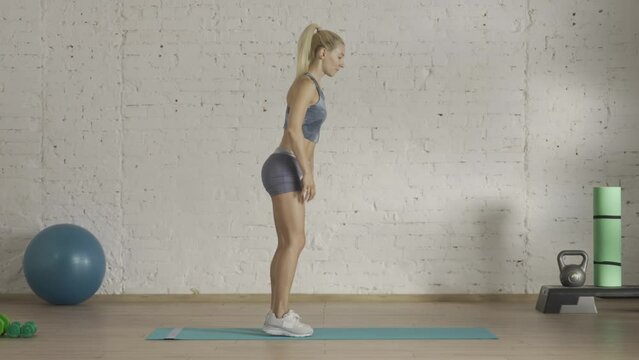 Healthcare and wellness advertisement concept. Athletic woman fitness coach doing explaining knee push ups for online classes. HDR BT2020 HLG material.