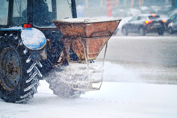 Tractor with salt bucket spread salt, deicing street. Utility vehicle melt ice. Tactor spreading...