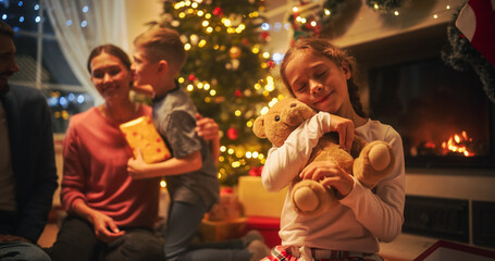 Loving Young Parents Giving Gifts to Their Children on Christmas Eve. Happy and Surprised Little...