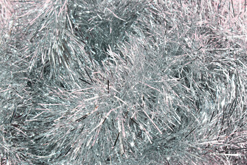 Shiny silver tinsel Christmas decoration. Holiday or celebration event concept.