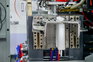 The white bottle container manufacturing process by blow mold machine.