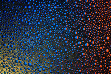 Emulsion of oil in water and air bubbles. Top view. Abstract background with multicolored bubbles.