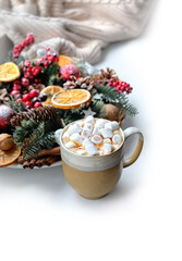 Coffee cup with marshmallows and festive decor close up on white table. Christmas, New Year holiday background. cozy home composition for winter festive season concept. copy space