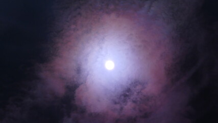 Dark night sky and moon with pink Lunar corona - abstract composition with optical phenomenon on...