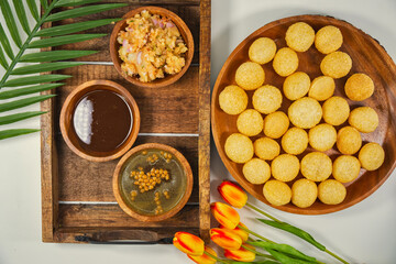 Gourmet Delight: Vibrant Pani Puri, India's Irresistible Street Food Sensation. The golden, crispy puris filled with a delightful spiced potatoes, chickpeas, and tamarind chutney. With aromatic paani