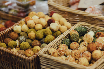 hand made baked stuffed rolls and pieces of cheese. Delicious pastries on wooden cutting board and parchment paper.