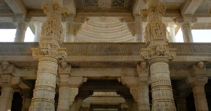 Columns of beautiful Ranakpur Jain temple or Chaturmukha Dharana Vihara. Marble ancient medieval carved sculpture carvings of sacred religious place of jainism worship. Ranakpur, Rajasthan. India