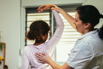Teen Girl having chiropractic back adjustment. Osteopathy, Physiotherapy, Kinesiology. Bad posture...