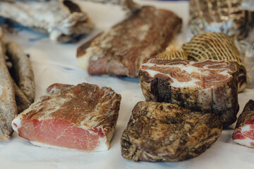 Hand made smoked meat products. Display meats, cold cuts and sausages at the street food fair. Soft focus blurred and noise effect. Delicatessen Concept