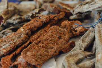 Hand made smoked meat products. Display meats, cold cuts and sausages at the street food fair. Soft focus blurred and noise effect. Delicatessen Concept