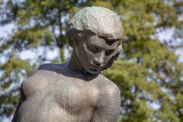 Fototapeta na wymiar Statue of a woman with a spear in a city park. Germany, Essen, Grugapark. High quality photo