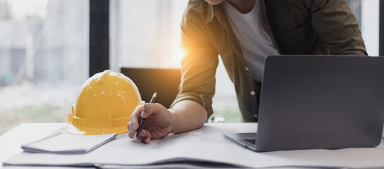 Engineer or home designer concept. Engineer working and architectural project and construction at desk in office, Modern Interior designer. 