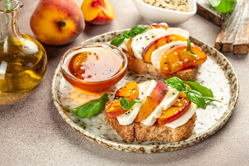 Breakfast sandwiches bread toast, bruschetta with grilled peaches and cheese. Healthy appetizer or snack. Food recipe background. Close up
