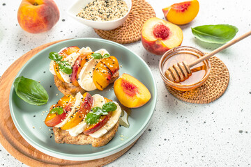 Peach prosciutto ham spinach bruschetta. Delicious appetizer for wine on a light background top view. place for text