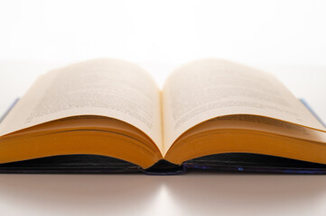 Open book and pages turned, backlit, on a white background. Passion for reading.
