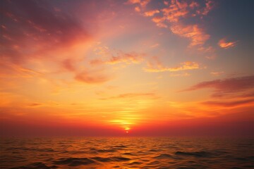 Naklejka na ściany i meble Sun dips below the horizon, casting a serene evening glow