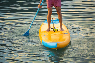 Man on sub board floating on ocean sea.