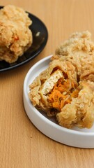 Fried tofu with spicy chiken filling. Often referred to as Tahu Mercon. Because it is deep fried, this tofu is also called Tahu Krispi. Traditional food from Indonesia which is crunchy and savory.