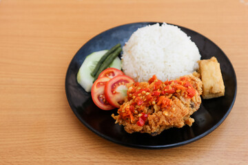 Ayam Geprek Indonesian Food crispy fried chicken with hot and spicy sambal Chili Sauce Served Steam Rice recipe.Currently ayam geprek found in Indonesia and neighbouring countries, Origin Yogyakarta