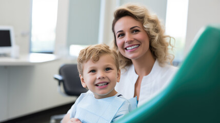 Fototapeta premium Smiling dentist and a small child at a dental clinic appointment