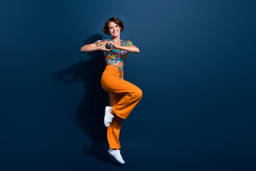 Full body photo of pretty young girl heart gesture shape jump wear trendy flared pants jeans...
