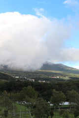 Mountains in clouds at sunrise in summer. Aerial view of mountain peak with green trees in sugadaira nagano japan.