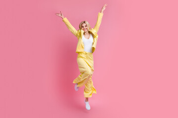 Full length photo of active elegant person raise hands jumping empty space isolated on pink color background