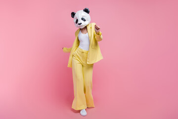 Full length photo of weird 3d panda mask classy person clubbing chilling empty space isolated on pink color background © deagreez
