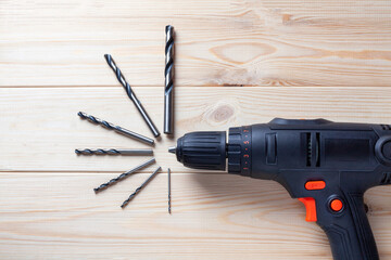 Close up Electric drill, Drill set, Screwdriver set on wooden table background. Electric cordless hand drill on wooden. maintenance home concept