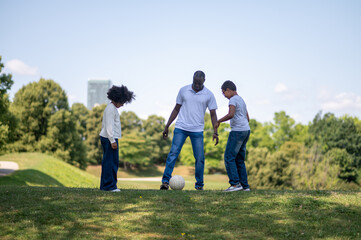 Fototapeta premium Happy family spending time together in a park and looking enjoyed