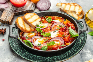Fried eggs with vegetables. shakshuka in a frying pan, Food recipe background. Close up