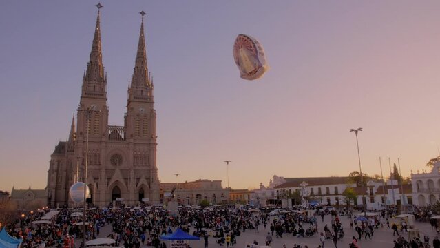 Panoramic view at sunset of the National Basilica of Luj&aacute;n in Argentina, during the 49th pilgrimage to the temple. The globe reads: "Blessed be your purity"