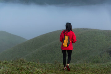 Hiker asian woman happy feeling freedom good and strong weight victorious facing on the natural mountain. Travel Concept