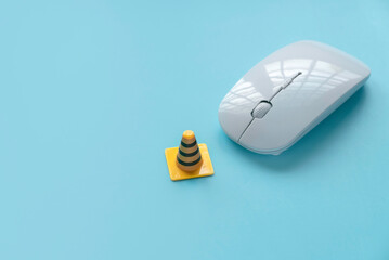 Fixing, maintenance and under construction concept.  Computer mouse with traffic cone.
