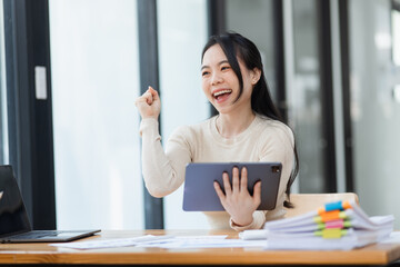 Woman worker feeling excited and euphoric winning, Young woman excited sitting at desk office, Overjoyed woman, Attractive woman triumph sit at desk wit digital tablet win online.