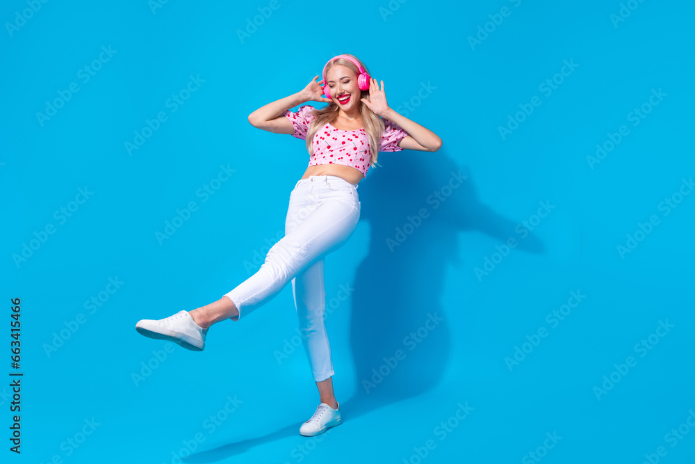 Poster full body photo of pretty young girl earphones dancing step promo wear trendy pink cherry print outf